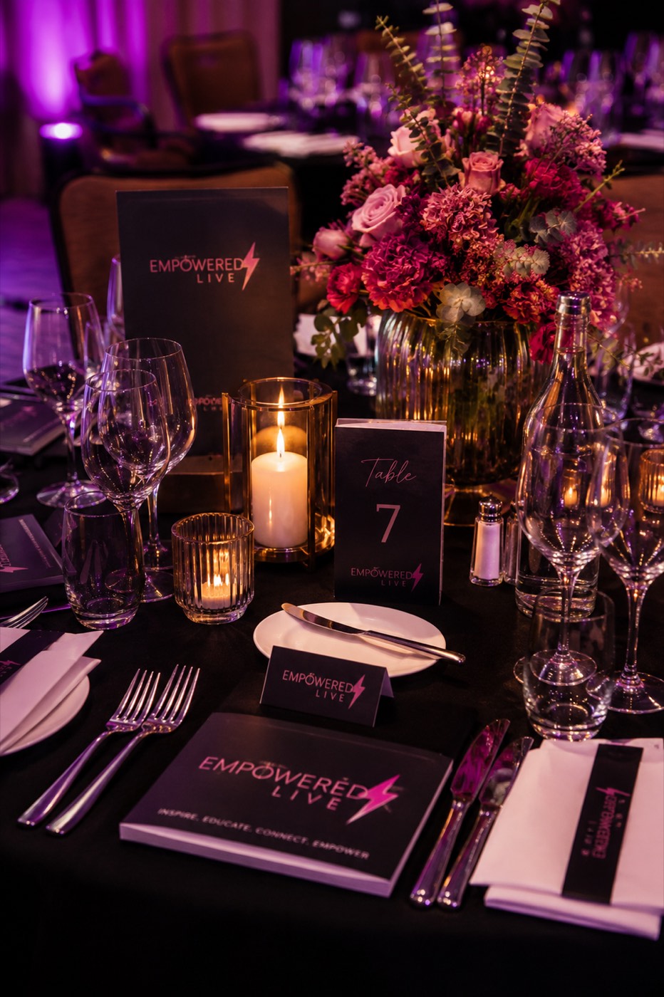 Candlelit tables set for the EMpowered Gala