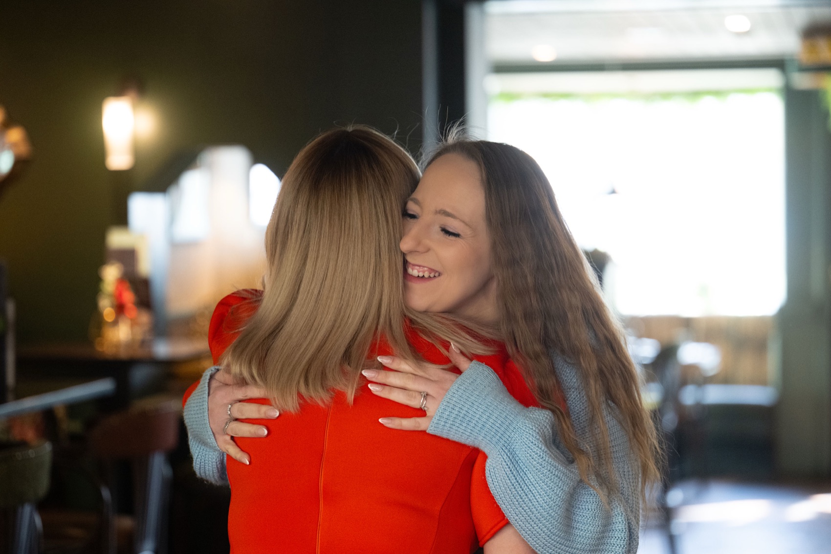 Two women embracing at an EMpowered with Emily event